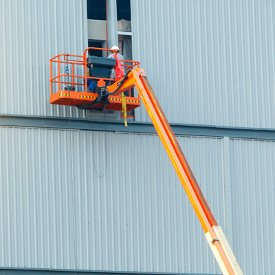 Workers following OSHA boom lift safety requirements