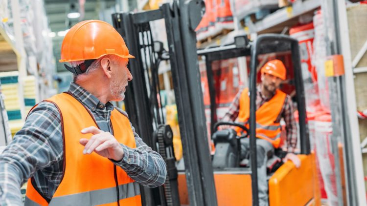 Two employee conducting a forklift inspection
