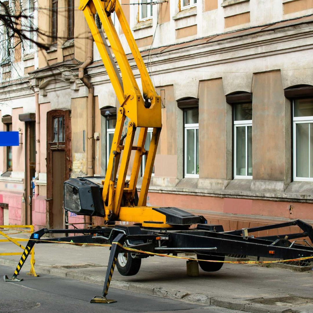 towable boom lift being used outside of a building
